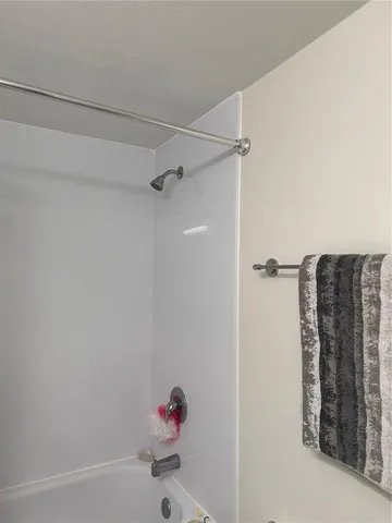 a bathroom with a tub and shower