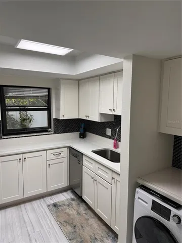 a kitchen with a sink and cabinets