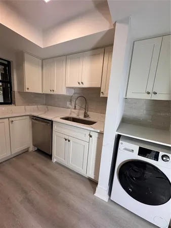 a kitchen with a sink and cabinets