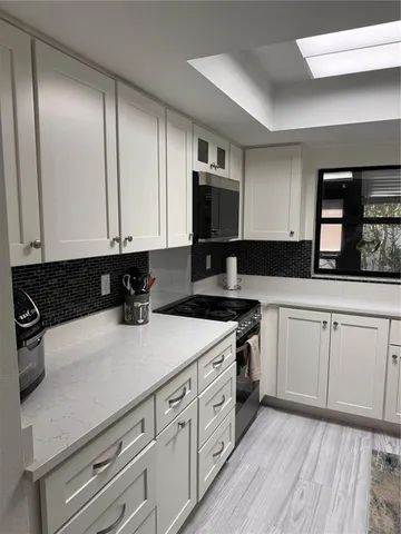 a kitchen with a white cabinets and sink