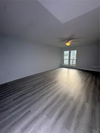 a view of an empty room and wooden floor