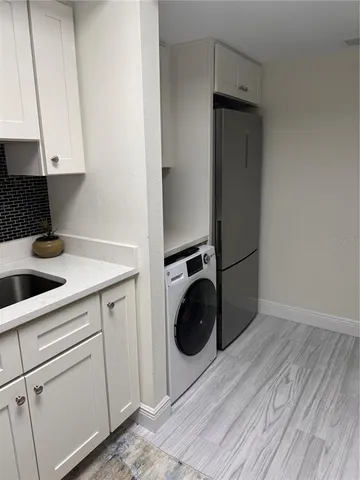 a kitchen with a refrigerator and cabinets