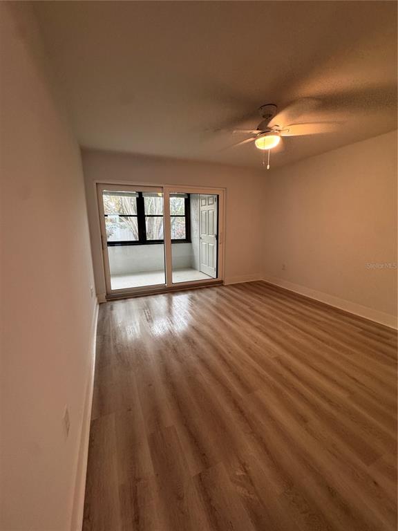 1 Windrush Boulevard, Unit 103 Indian Rocks Beach, FL 33785 - Photo 9 of 16 wooden floor in an empty room with a window