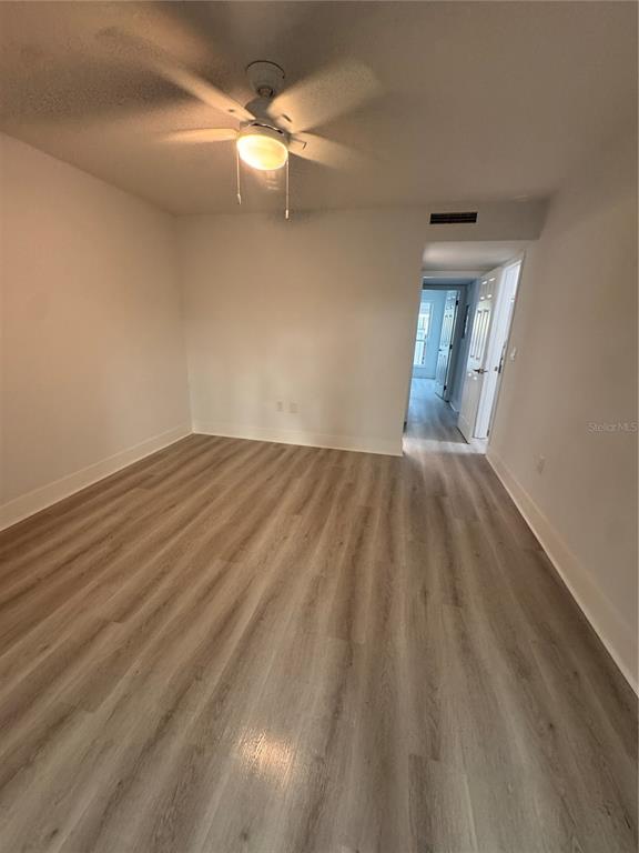 1 Windrush Boulevard, Unit 103 Indian Rocks Beach, FL 33785 - Photo 10 of 16 wooden floor in an empty room
