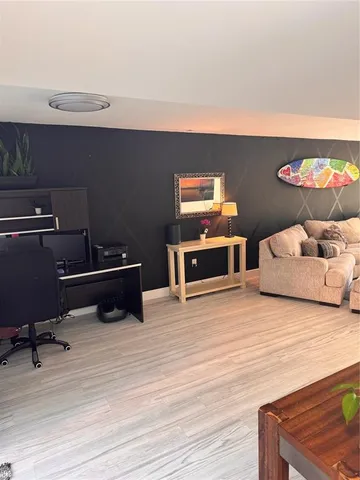 a bedroom with furniture and a wooden floor