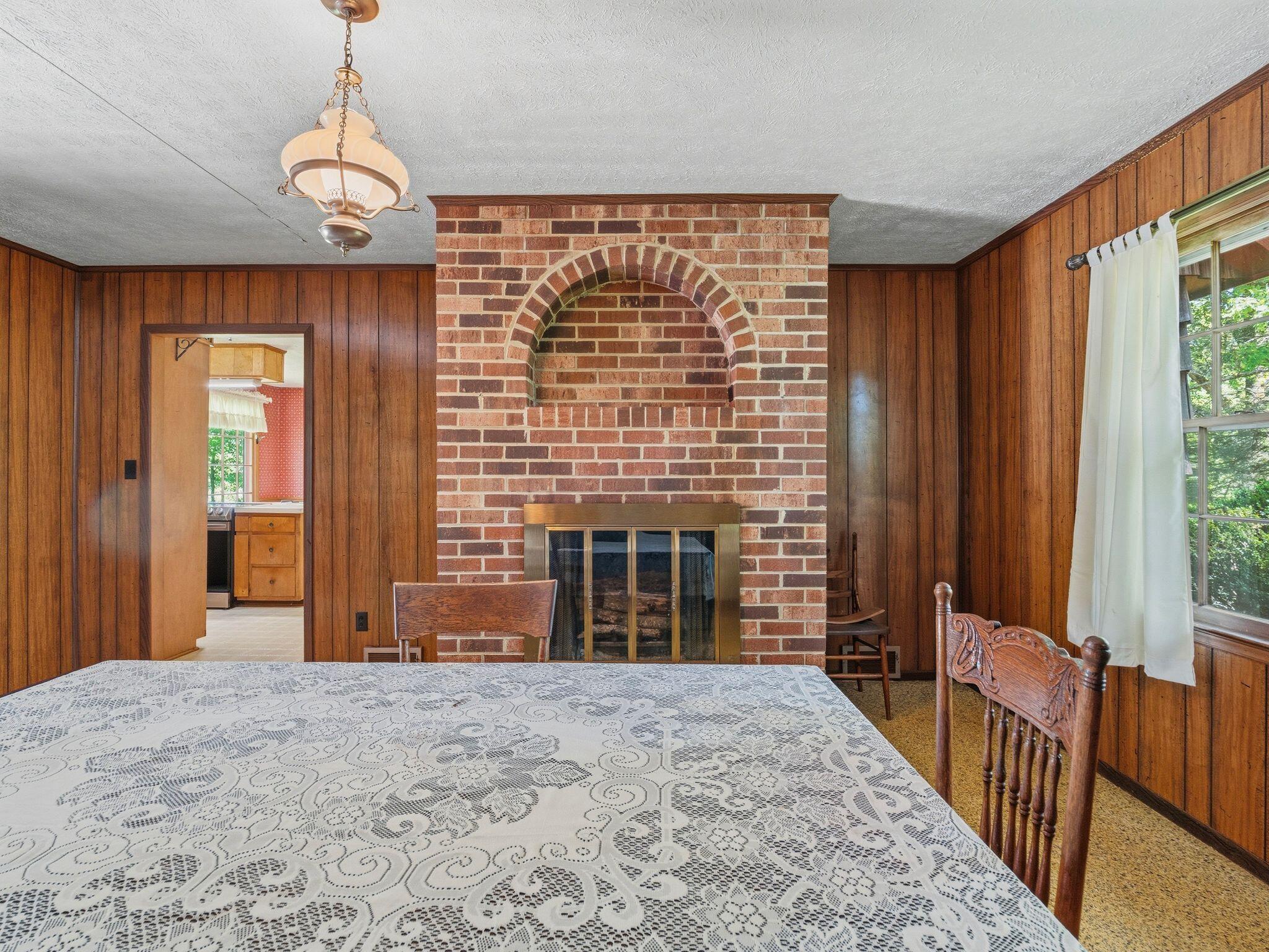 1115 Robin Ridge Road Henry, VA 24102 - Photo 14 of 54 a view of an empty room with a fireplace and a window