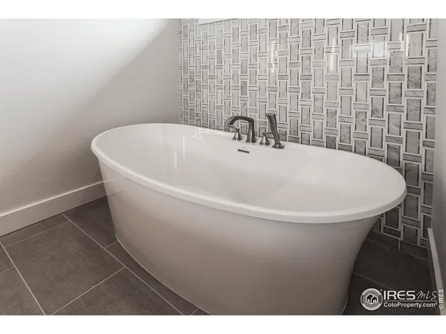 a white bath tub sitting in a bathroom