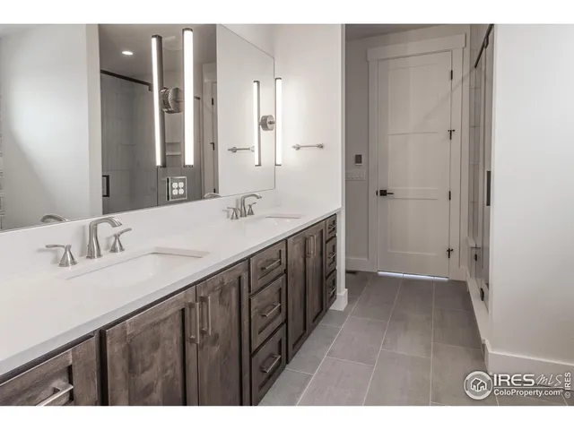 a bathroom with a double vanity sink and mirror
