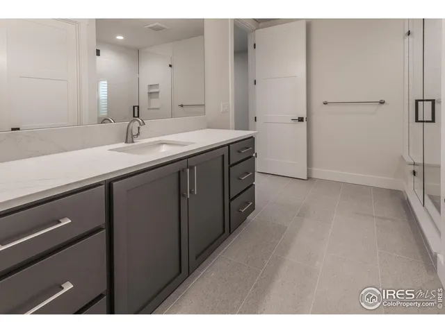 a bathroom with a double vanity sink a and mirror