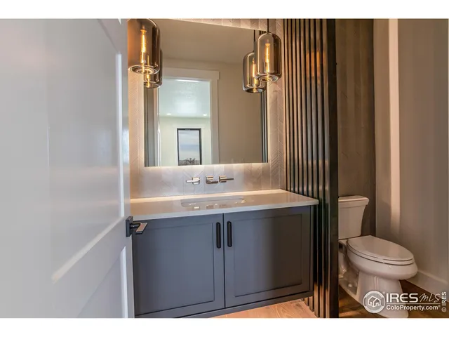 a bathroom with a sink toilet and mirror
