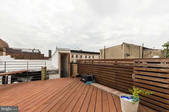 a view of a balcony with wooden floor and city view