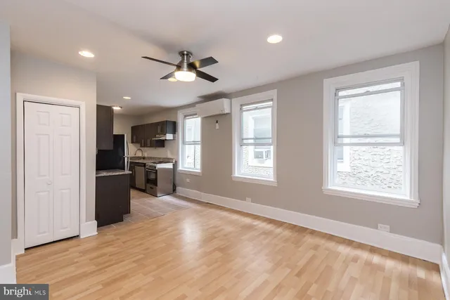 a view of a kitchen with a sink a refrigerator and window