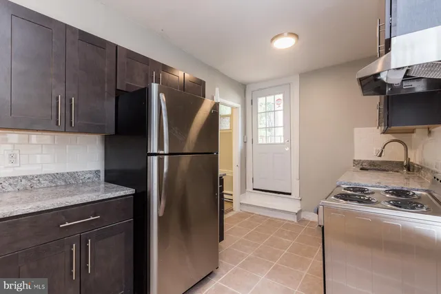 a kitchen with a refrigerator and a sink