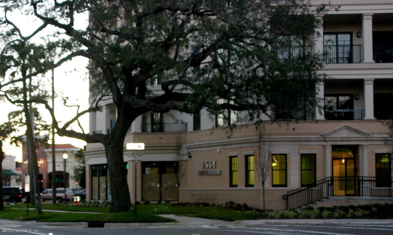 a front view of residential houses with yard