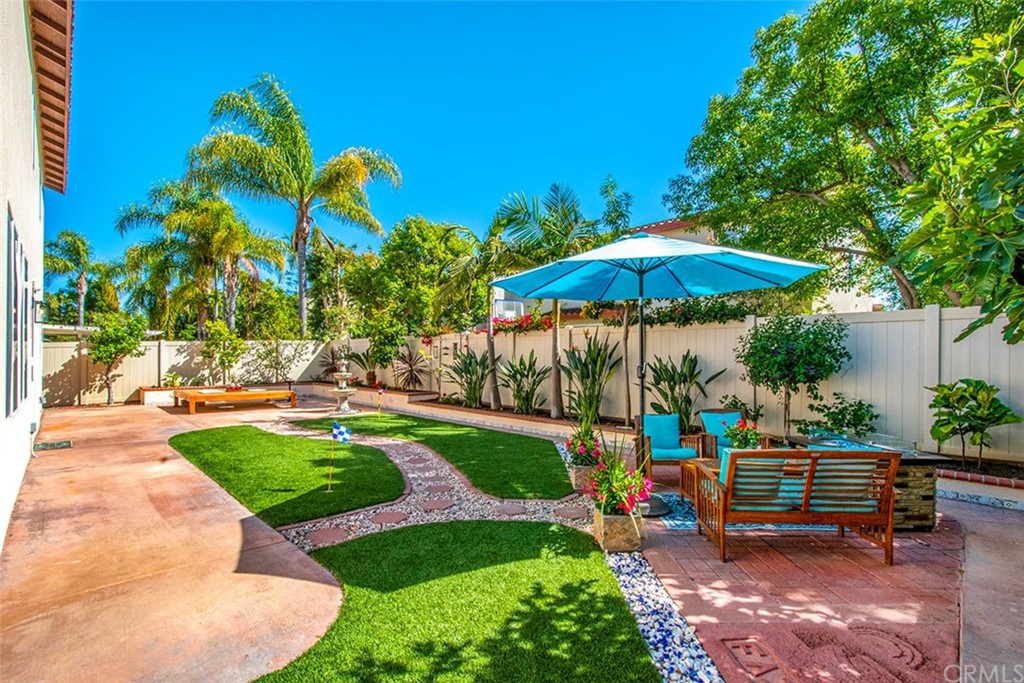 2 Ashford Irvine, CA 92618 - Photo 30 of 42 a view of a backyard with chairs under an umbrella