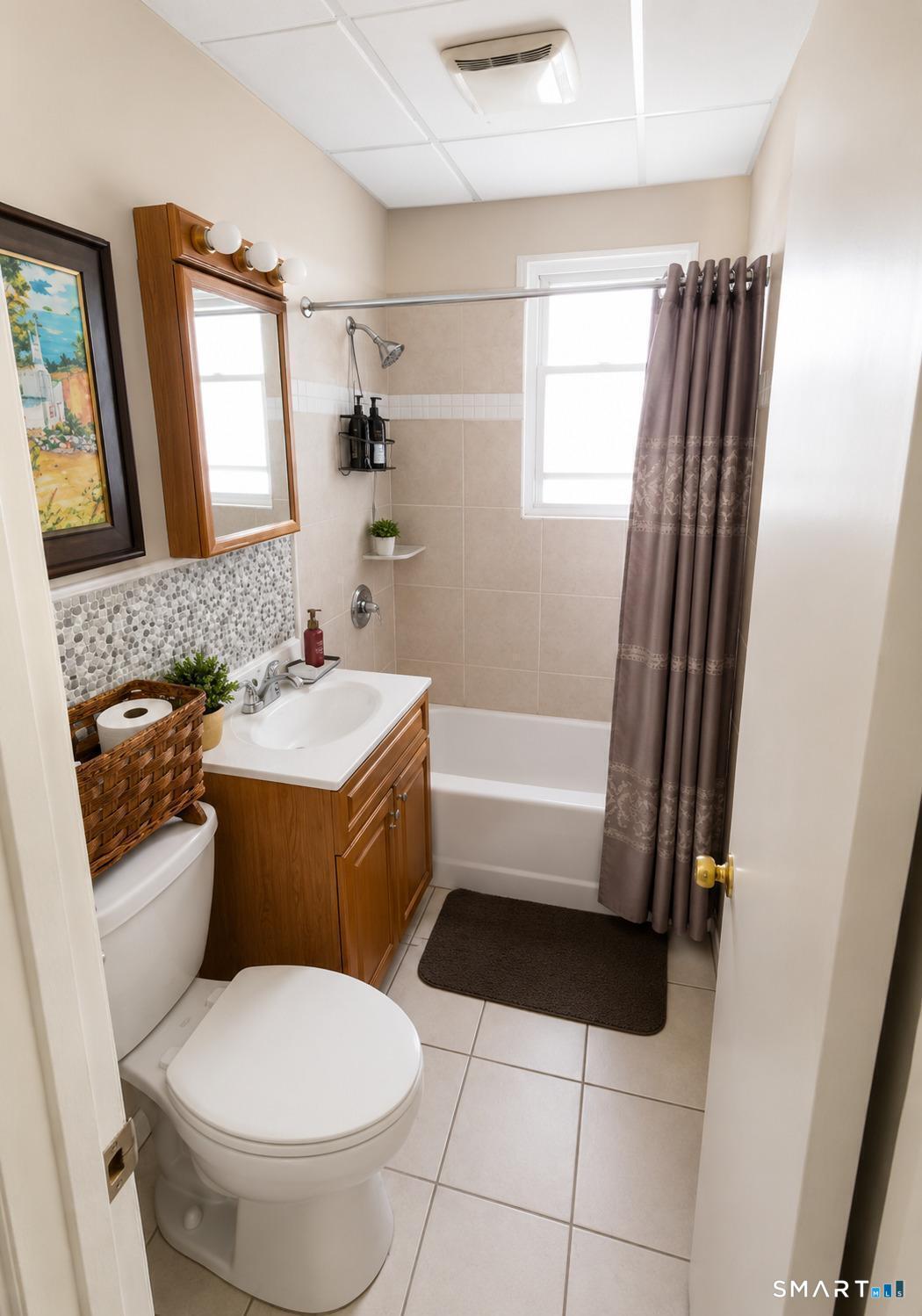 61 Bartlett Street Meriden, CT 06451 - Photo 11 of 30 a bathroom with a sink toilet and shower