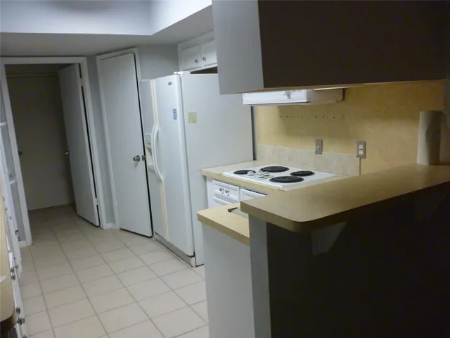 a view of a kitchen with white cabinets and stainless steel appliances