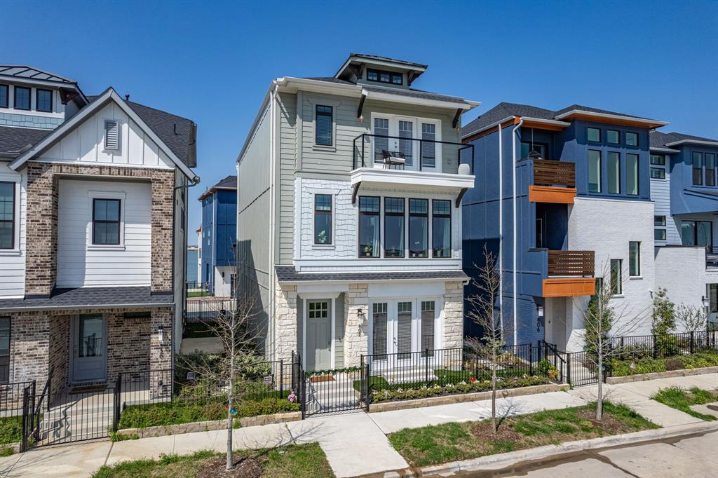 View of front of house with a gate, a fenced front yard, stone siding, french doors, and board and batten siding
