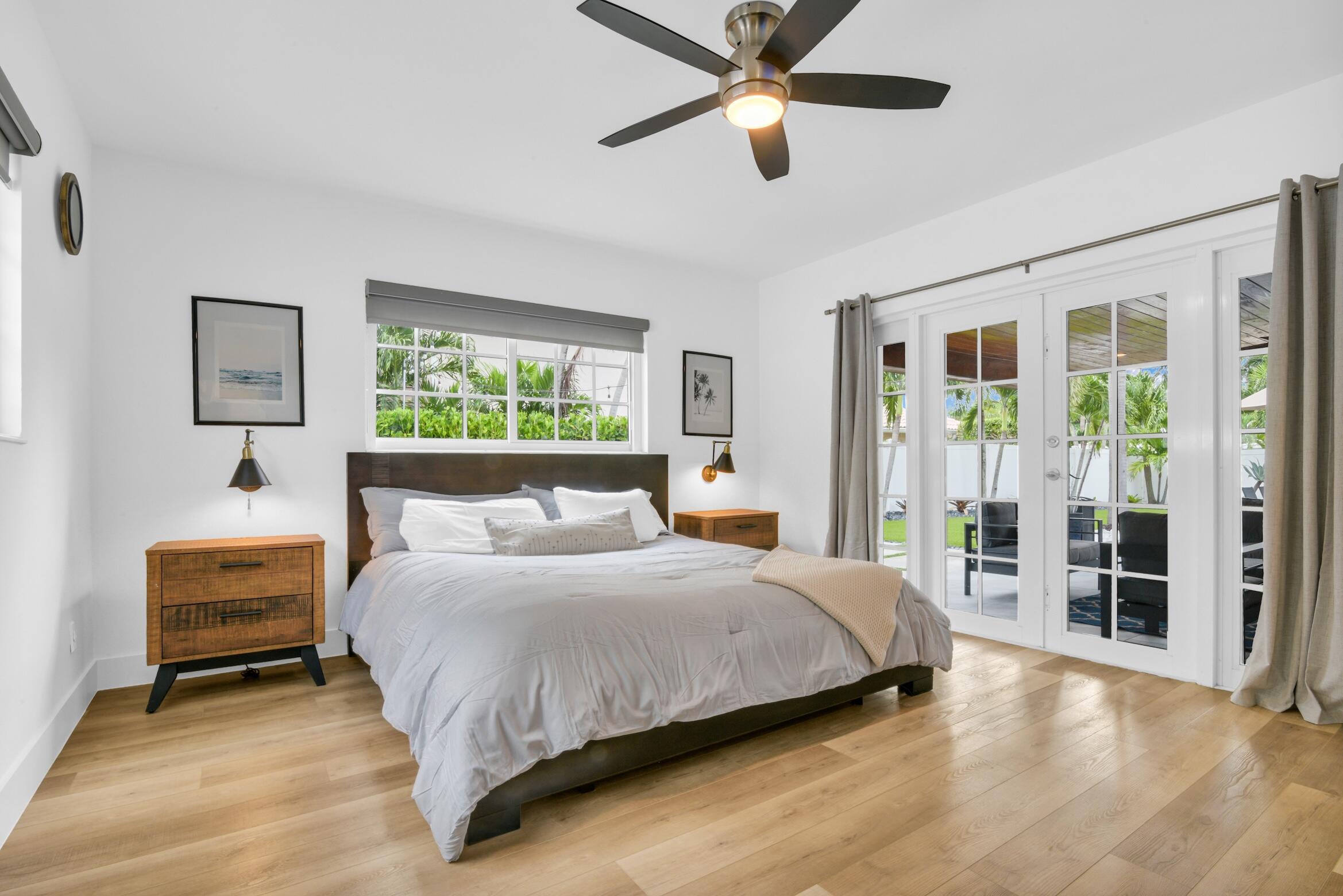 701 Appleby Street Boca Raton, FL 33487 - Photo 26 of 47 a bedroom with a large bed and a chandelier