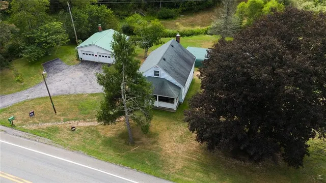 a view of a white house with yard