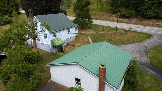 a view of a small house with a yard