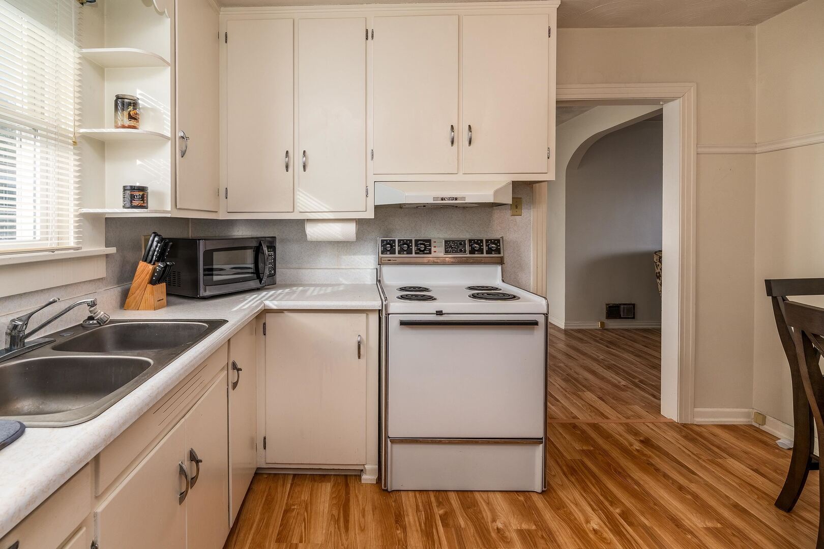 103 North 22nd Street Murphysboro, IL 62966 - Photo 11 of 23 a kitchen with cabinets appliances and a wooden floor