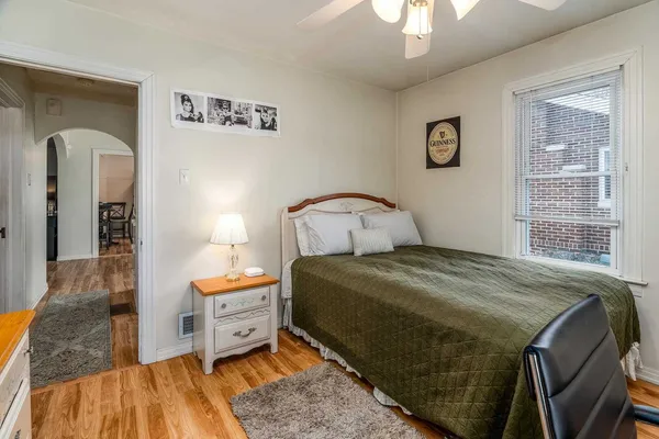 a bedroom with a bed and a mirror