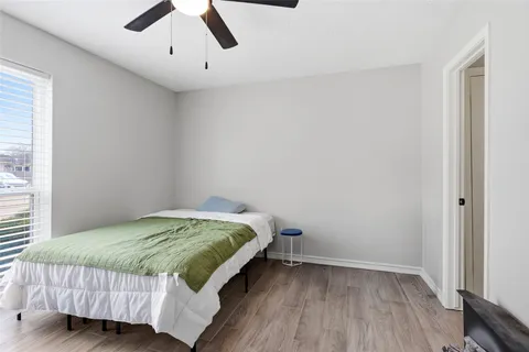 a bedroom with a bed and a painting on the wall