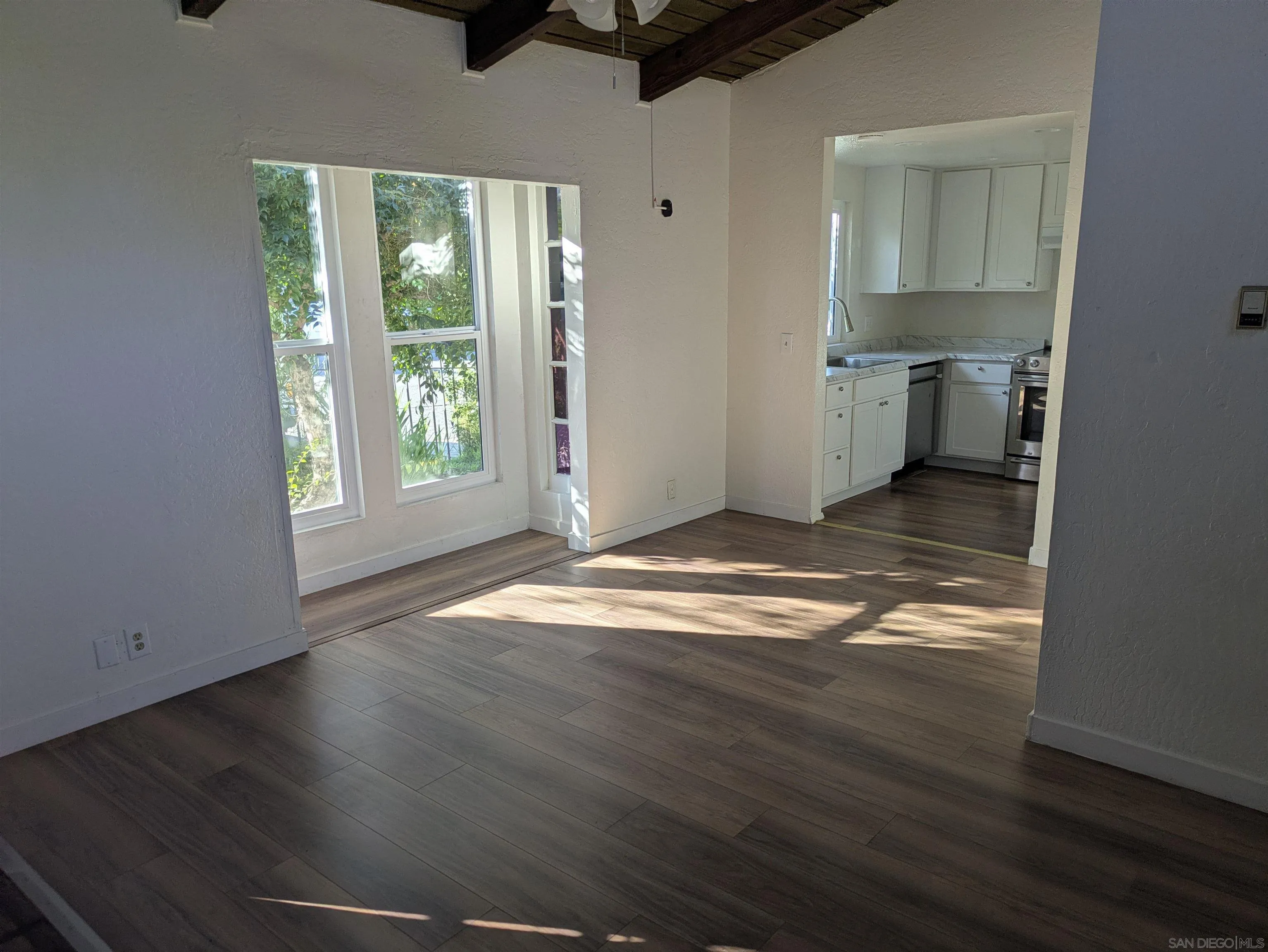 226 South Grape Street Escondido, CA 92025 - Photo 1 of 5 an empty room with wooden floor cabinet and windows