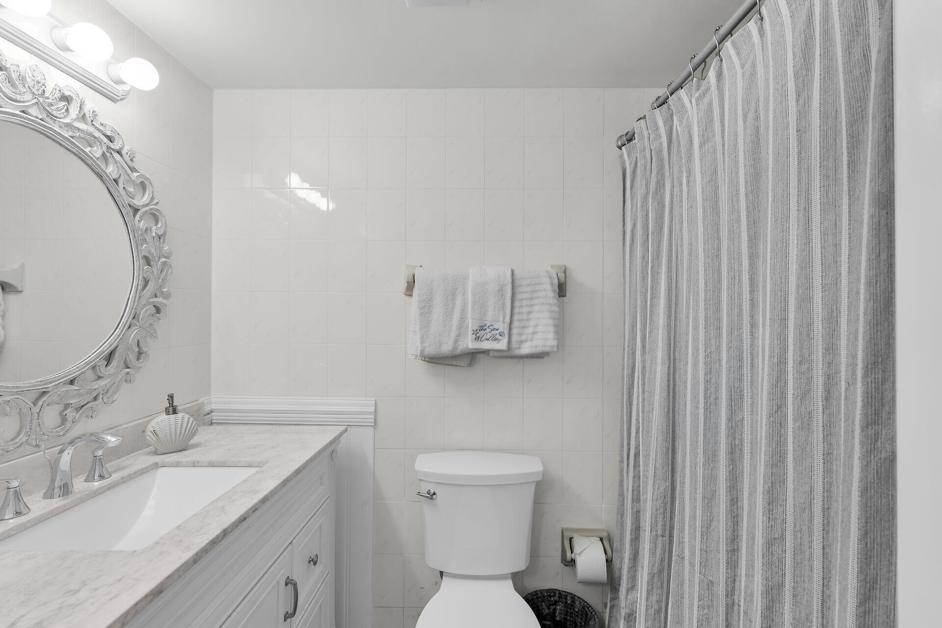 351 10th Street Key Colony Beach, FL 33051 - Photo 28 of 48 a bathroom with a sink and mirror with toilet