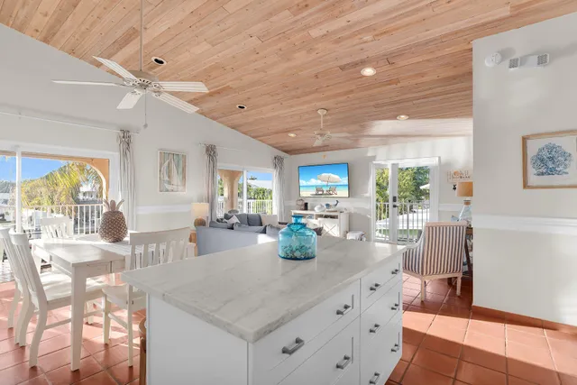a kitchen with granite countertop a table and chairs in it