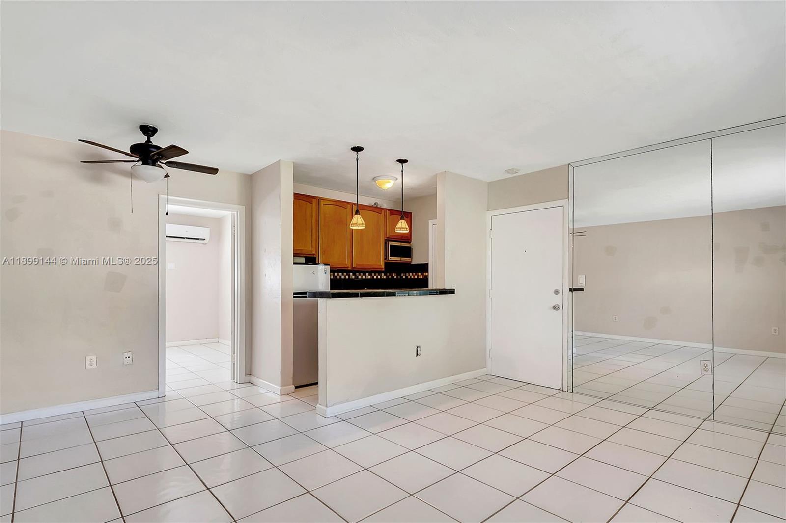 6310 Southwest 79th Street, Unit 19 South Miami, FL 33143 - Photo 2 of 8 a view of a refrigerator and window in a room