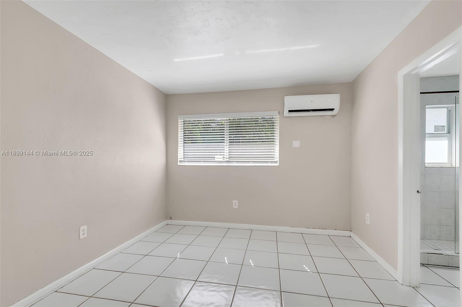 6310 Southwest 79th Street, Unit 19 South Miami, FL 33143 - Photo 4 of 8 a view of an empty room with a window