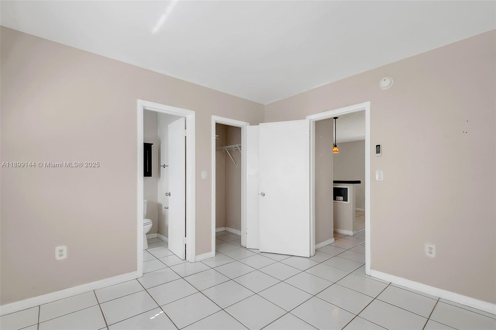 6310 Southwest 79th Street, Unit 19 South Miami, FL 33143 - Photo 6 of 8 a view of a room with white walls and entryway