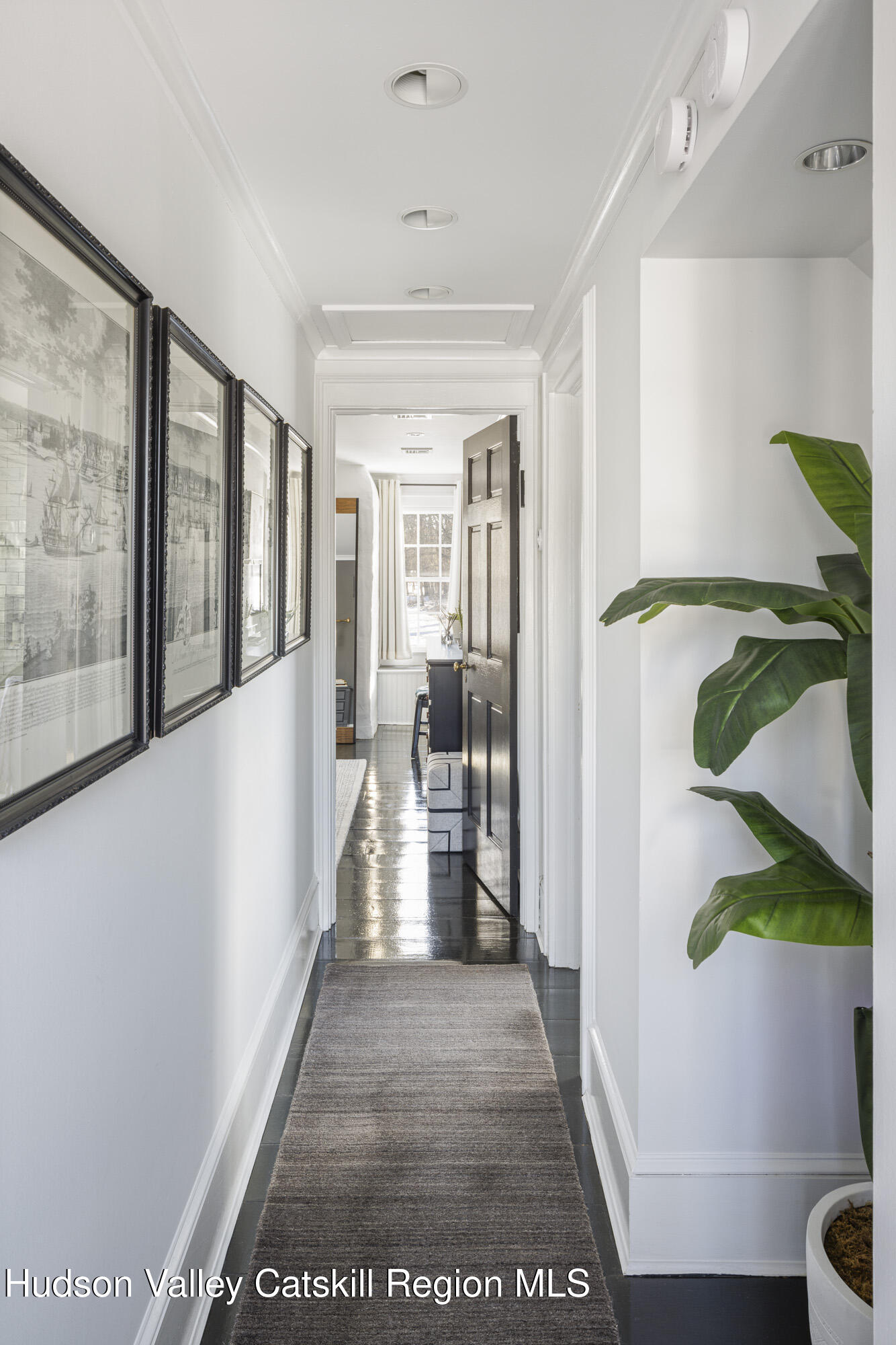 2887 Highway 209 Marbletown, NY 12401 - Photo 18 of 33 a view of a hallway to a livingroom with furniture and wooden floor