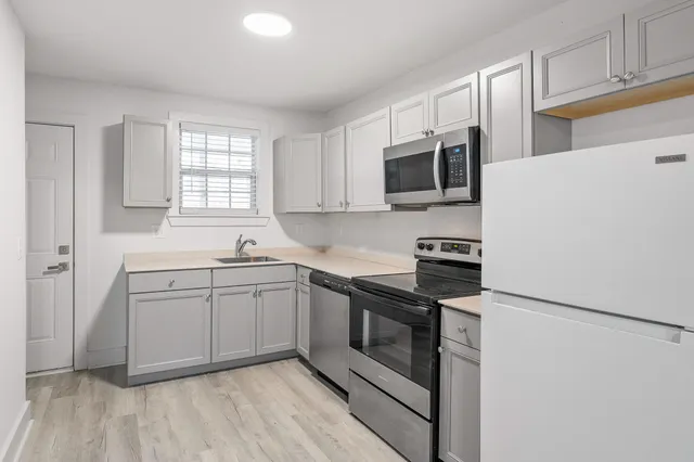 a kitchen with a sink stove and microwave