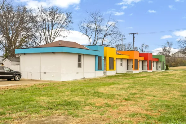 a front view of house with yard and trees