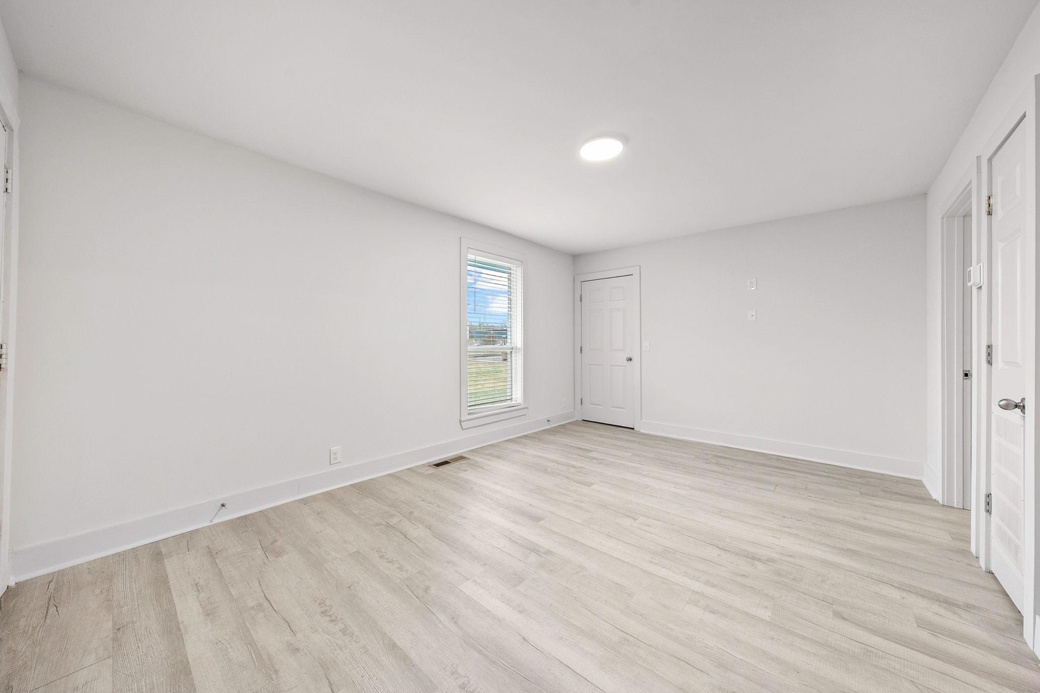 605 40th Avenue North, Unit E Nashville, TN 37209 - Photo 5 of 21 an empty room with wooden floor and windows