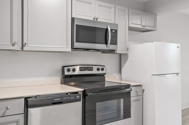 a kitchen with stainless steel appliances a stove a microwave and cabinets