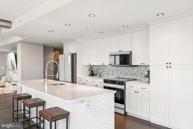 a kitchen with a stove a sink and a refrigerator