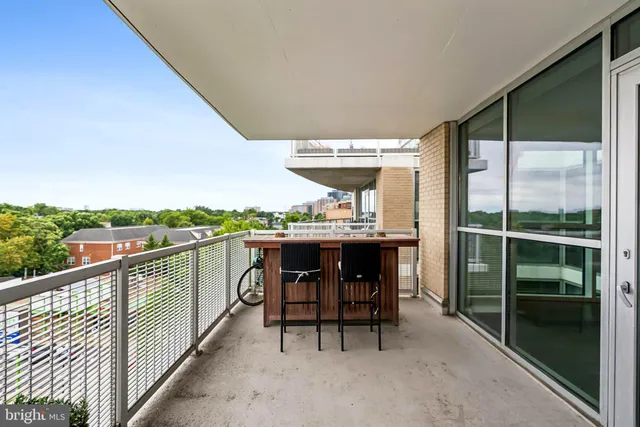 a balcony with table and chairs