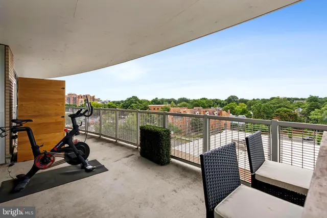 a view of a lake with couches and wooden floor