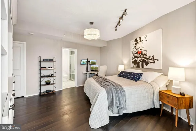 a bedroom with a large bed and a wooden floor