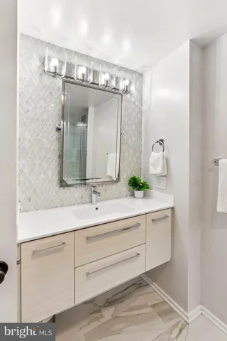 a bathroom with a double vanity sink and mirror
