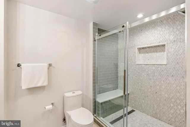 a bathroom with a toilet a sink and shower