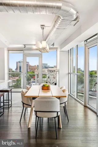 a view of a dining room with furniture window and wooden floor