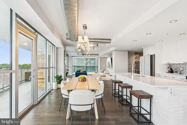 a view of a dining room with furniture wooden floor and chandelier