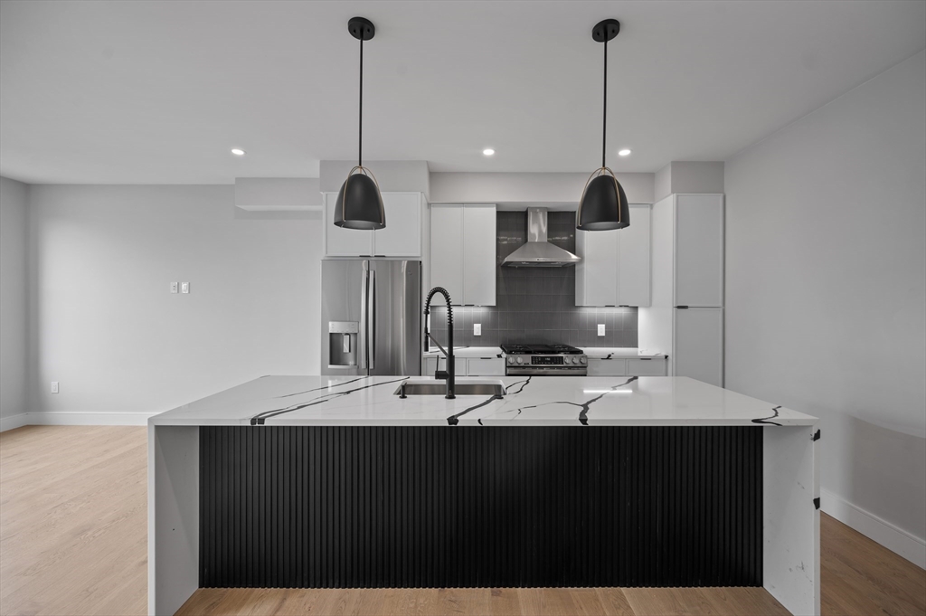 70 Shawsheen Road, Unit 1 Boston, MA 02128 - Photo 2 of 6 a bathroom with a sink and a mirror