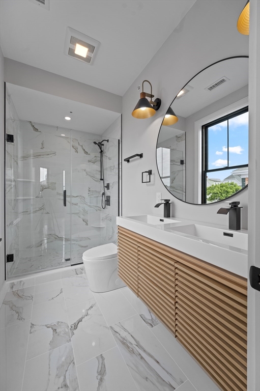 70 Shawsheen Road, Unit 1 Boston, MA 02128 - Photo 4 of 6 a bathroom with a sink a toilet and shower