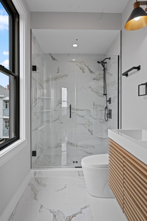 70 Shawsheen Road, Unit 1 Boston, MA 02128 - Photo 5 of 6 a bathroom with a toilet and shower